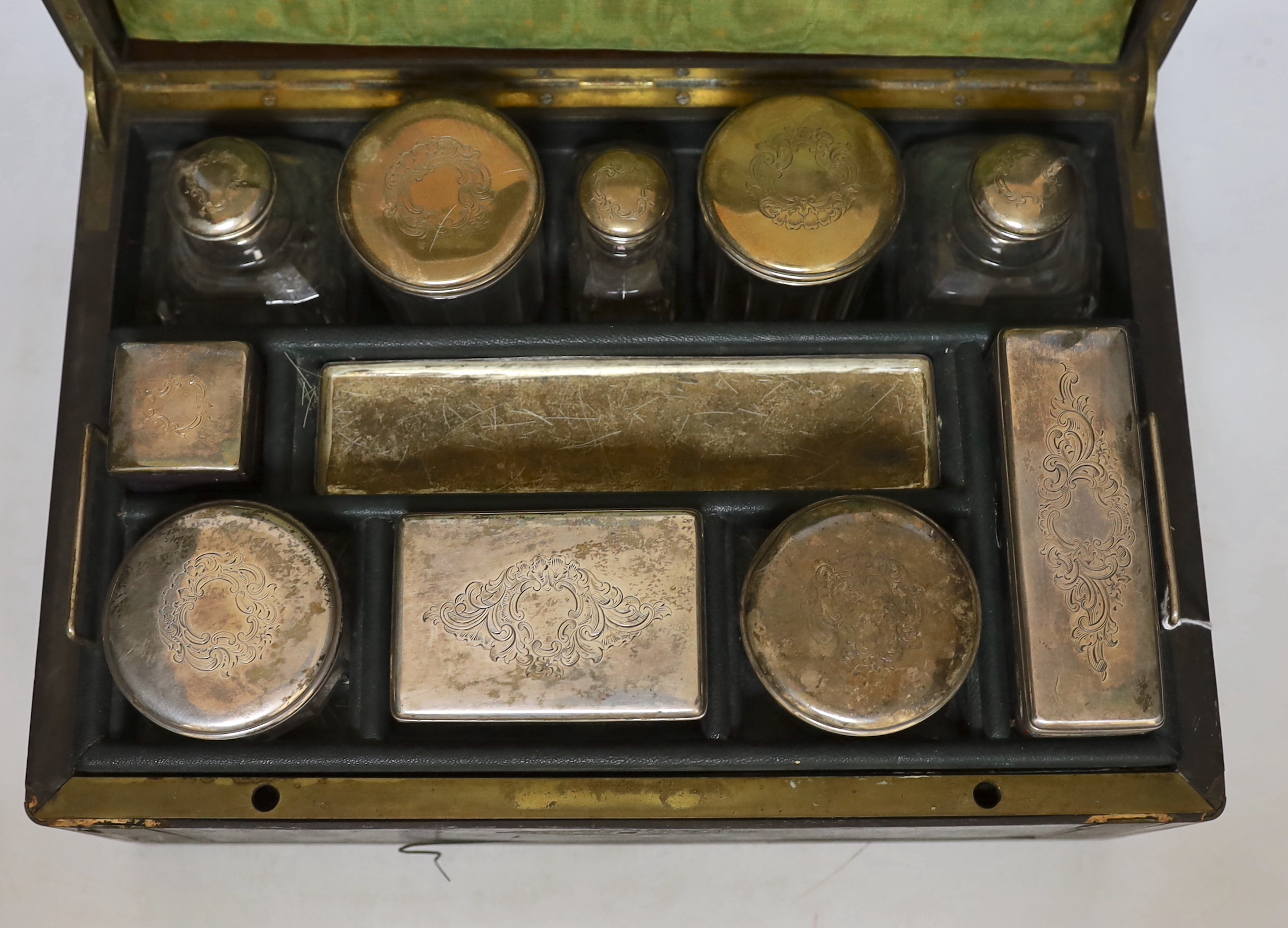 A Victorian vanity case with French white metal lidded jars, 35cm wide
